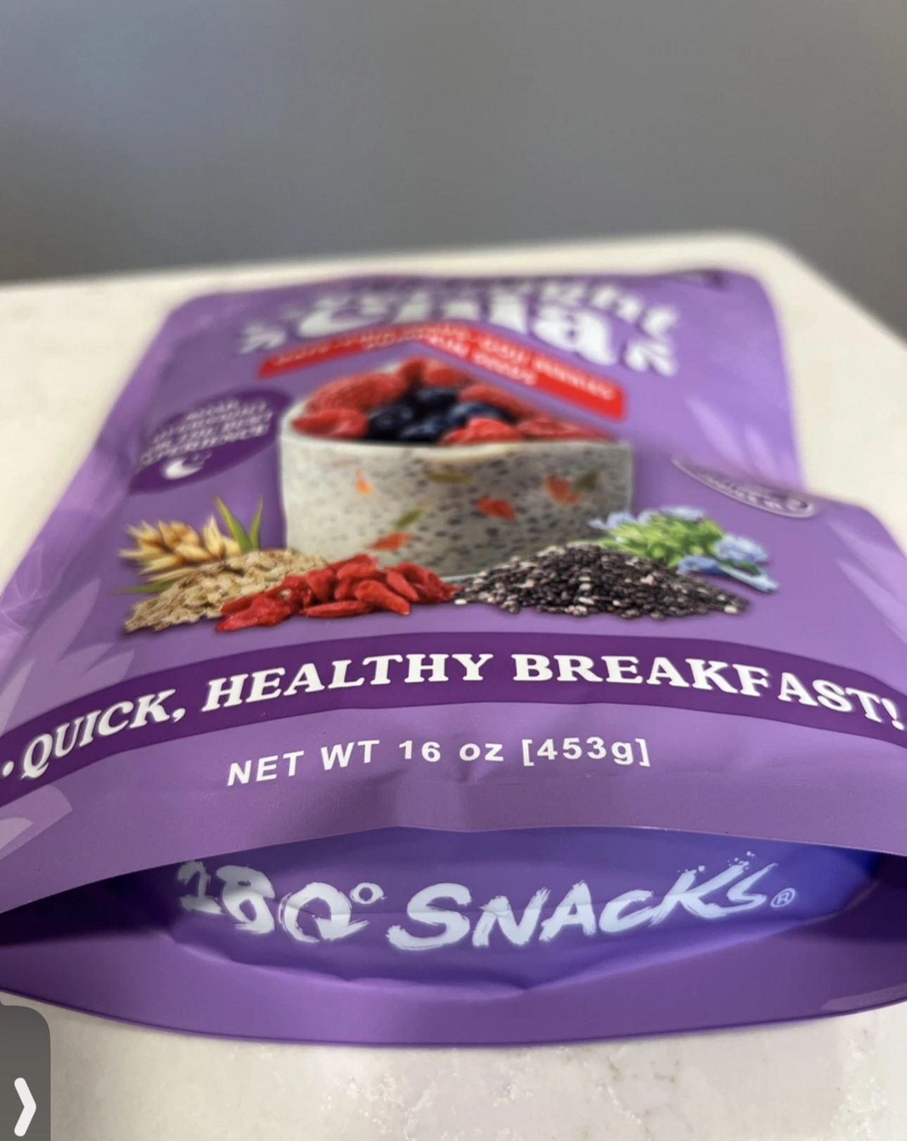 Overnight chia mix with oats, chia seeds, goji berries, and pumpkin seeds in purple resealable pouch