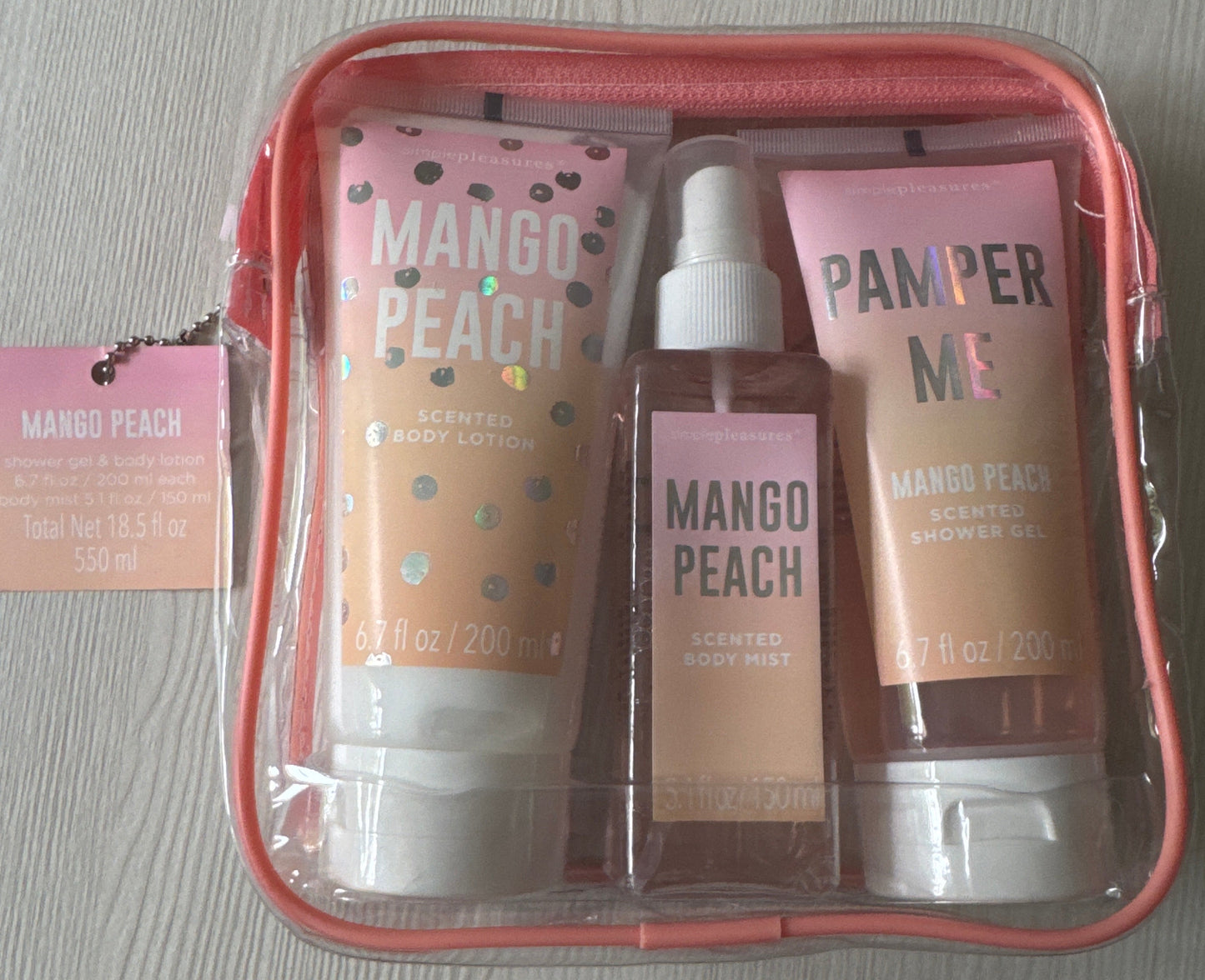 Simple Pleasures full-size mango peach body care set with lotion, mist, and shower gel in pink zip pouch