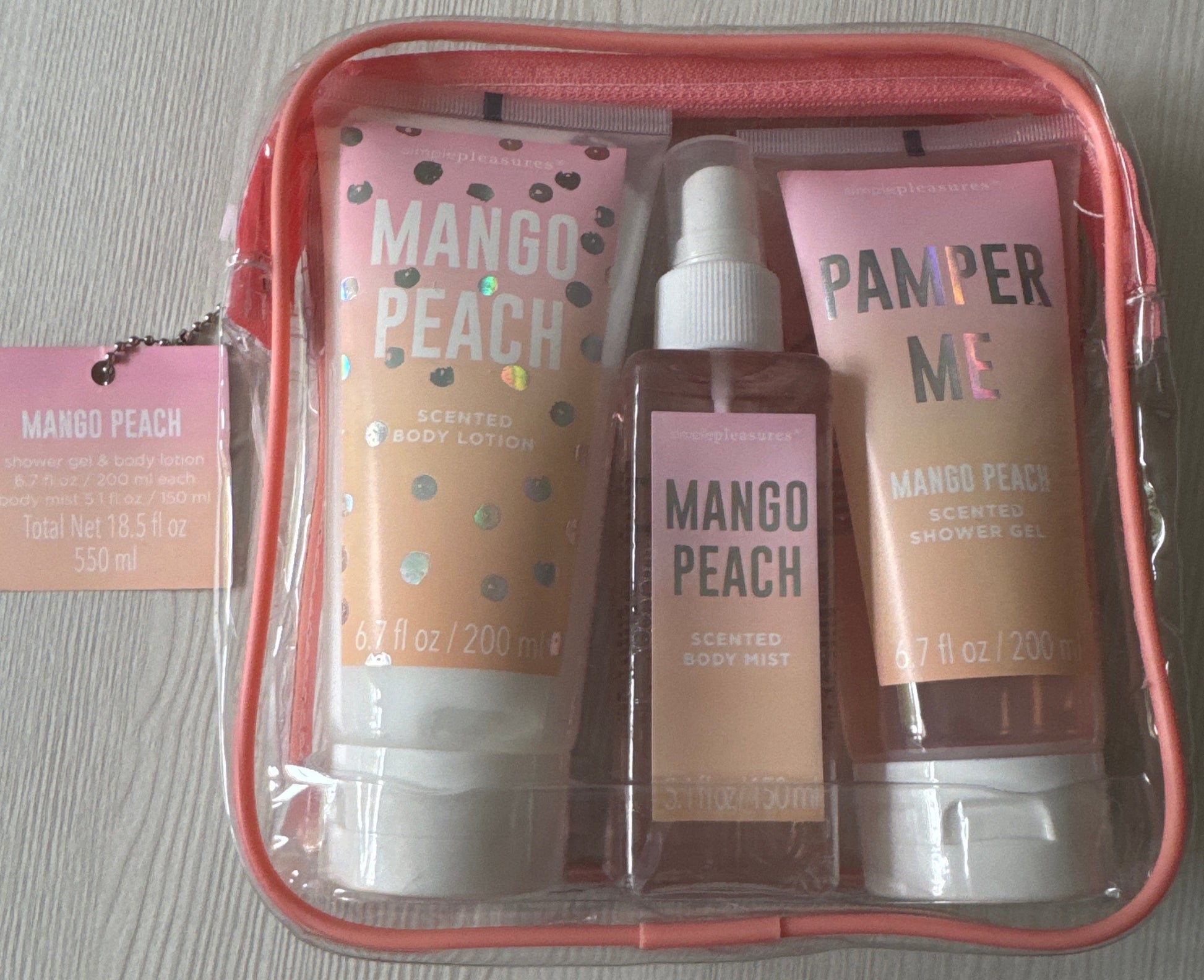 Simple Pleasures full-size mango peach body care set with lotion, mist, and shower gel in pink zip pouch