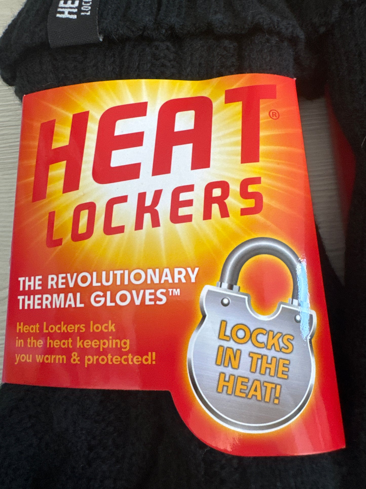 Two pairs of black Heat Locker thermal winter gloves with red and yellow packaging for cold weather insulation