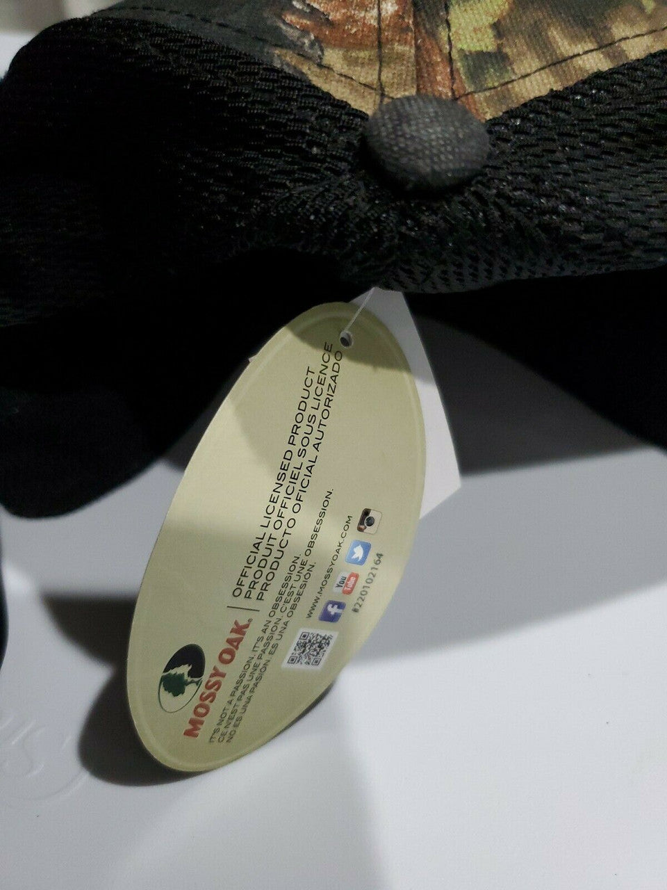 Mossy Oak men’s black camo stretch-fit hat in size S/M with logo patch and breathable mesh back, shown from multiple angles.