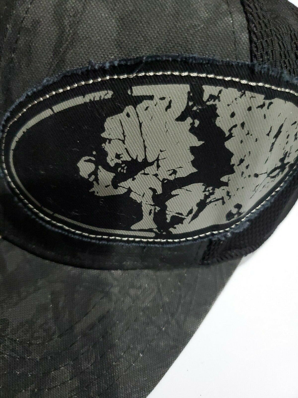 Mossy Oak men’s black camo stretch-fit hat in size S/M with logo patch and breathable mesh back, shown from multiple angles.