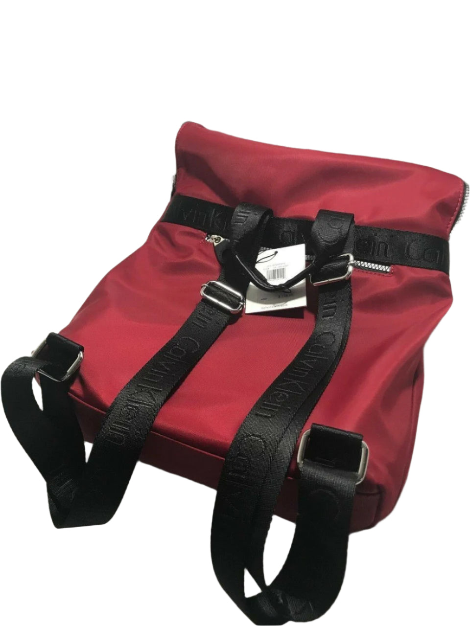 Red and black Calvin Klein backpack with large front logo, flap closure, and adjustable straps