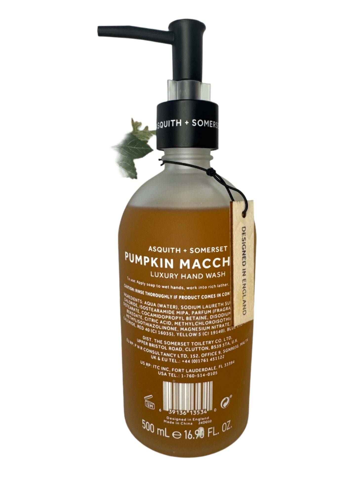 Elegant frosted glass bottle of fall-scented Pumpkin Macchiato hand soap with black pump dispenser, placed next to seasonal décor.
