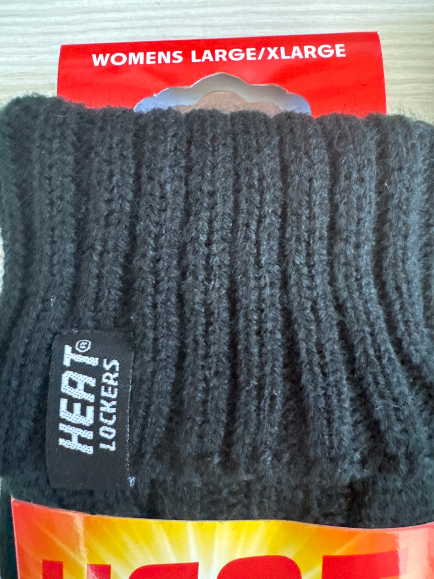 Two pairs of black Heat Locker thermal winter gloves with red and yellow packaging for cold weather insulation