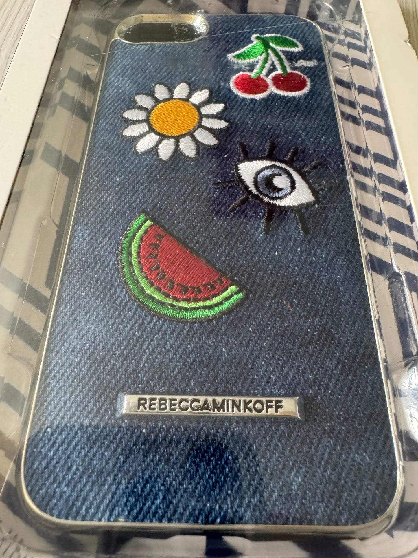 iPhone 7 denim phone case with embroidered watermelon, daisy, cherries, and eye design in original Luxe Double Up packaging.