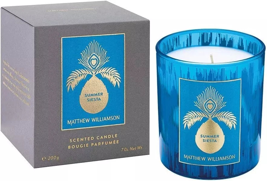 Blue glass candle jar with elegant pineapple and peacock design by Matthew Williamson.