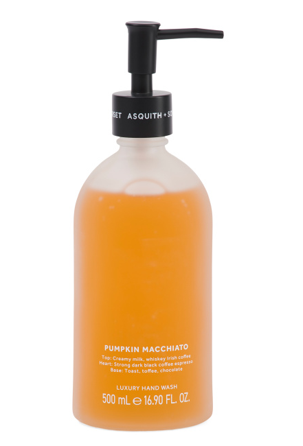 Elegant frosted glass bottle of fall-scented Pumpkin Macchiato hand soap with black pump dispenser, placed next to seasonal décor.