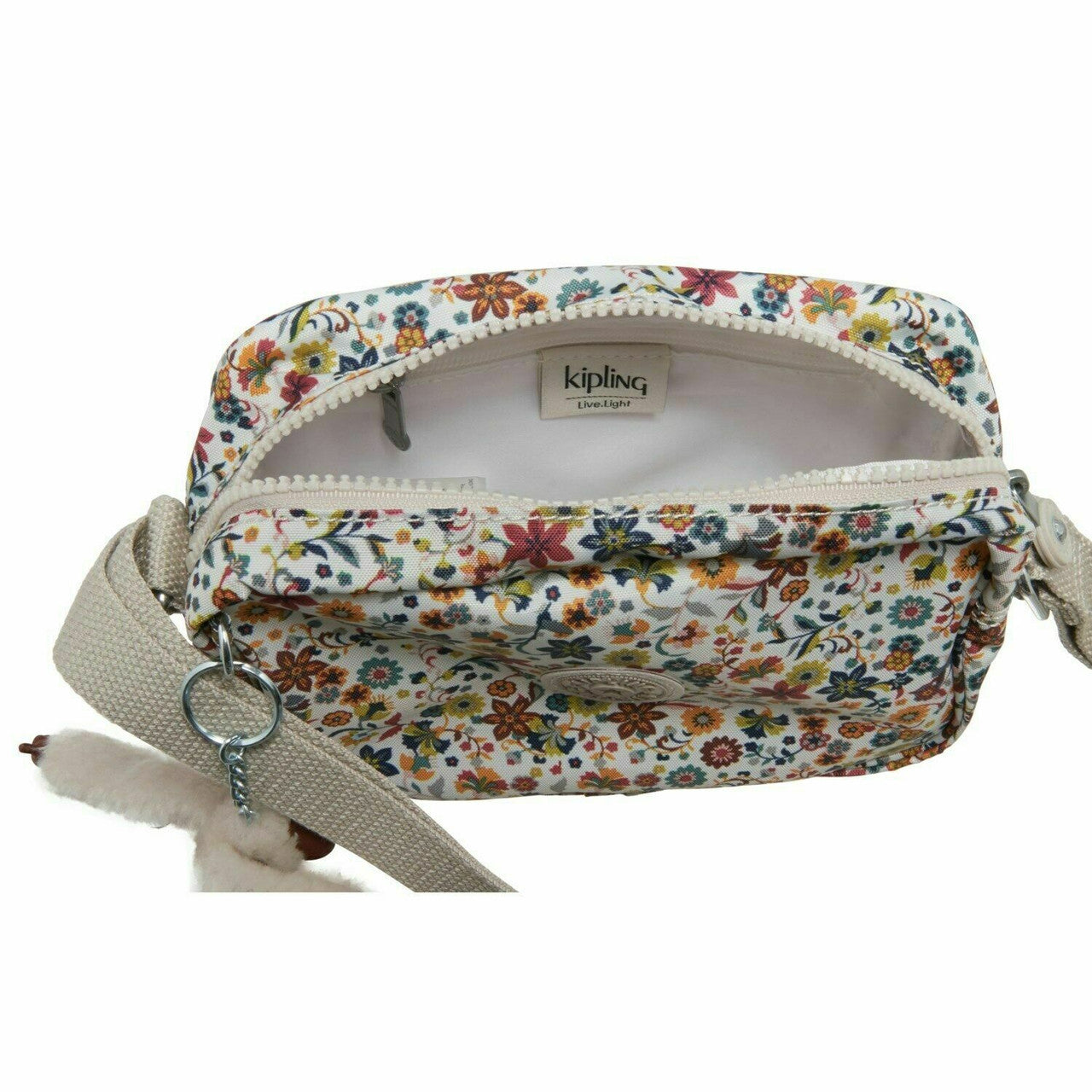 Kipling Daphne crossbody bag in Chatty Daisies print, 5.5″ × 8″ nylon handbag with adjustable strap, zip closure, and gorilla keychain.