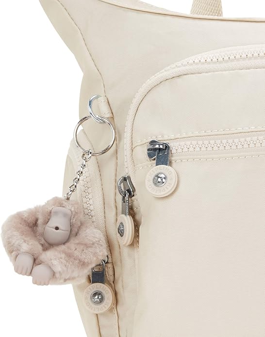 Lightweight cream nylon crossbody shoulder bag with multiple zipper pockets, adjustable strap, and plush monkey keychain – size 11.5" x 8.75" x 6.5"