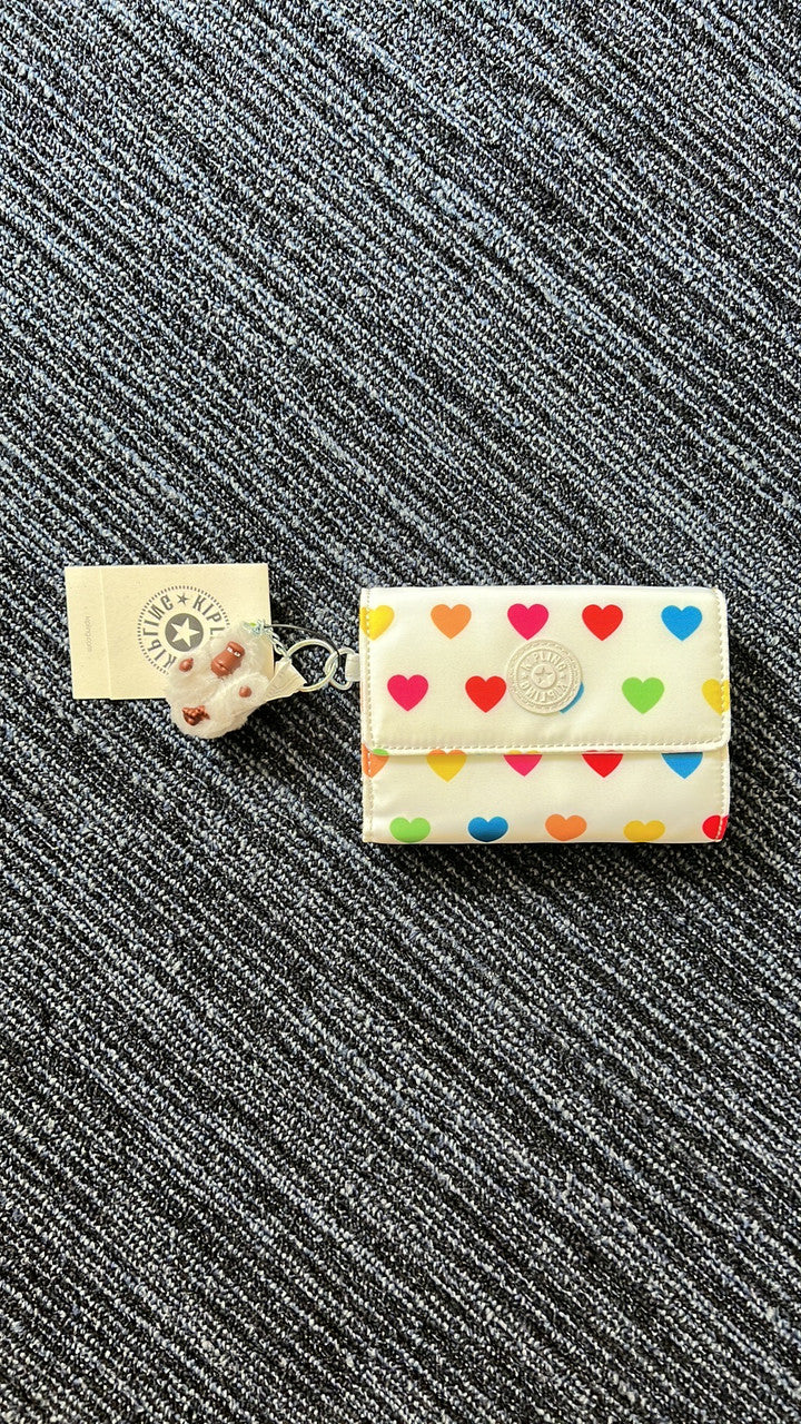 Kipling Pixi AC3739 Medium Organizer Wallet in Wild Hearts White, nylon material, with 8 card slots, bill pocket, zip divider, back slip pocket, and detachable monkey keychain, approx. 7.5" × 4.25" × 1.25".