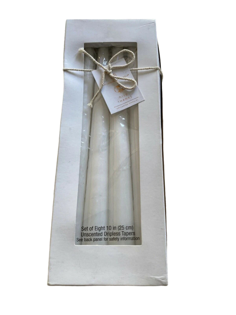 Set of 8 dripless unscented white taper candles in original packaging, ideal for elegant home decor or events