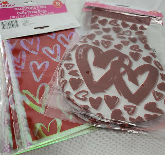 Six packages of red treat bags with multicolored heart patterns