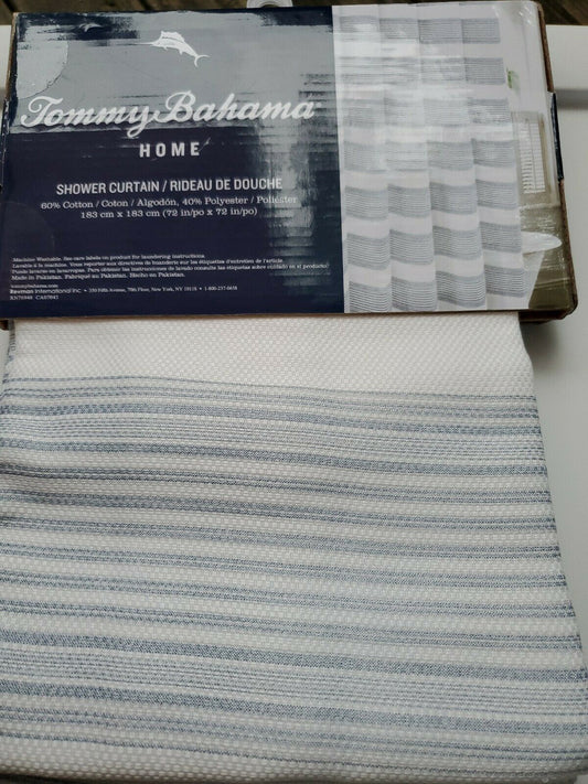 Textured blue and white striped shower curtain by Tommy Bahama folded with product label visible