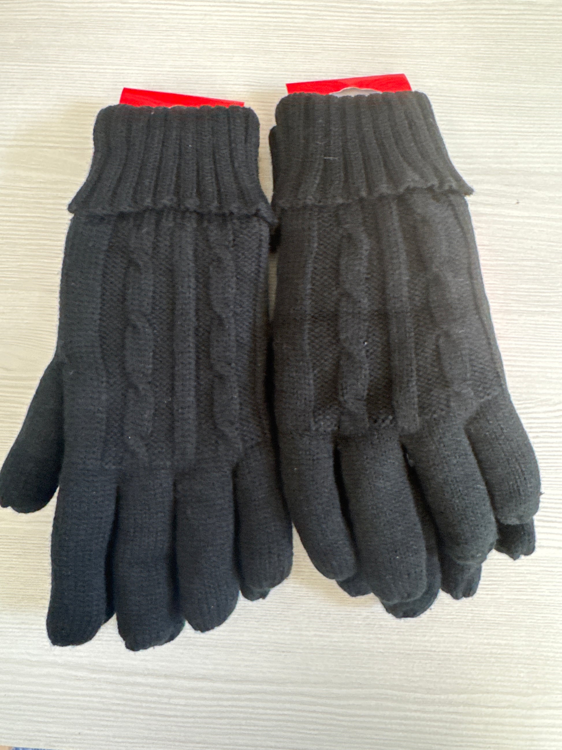 Two pairs of black Heat Locker thermal winter gloves with red and yellow packaging for cold weather insulation